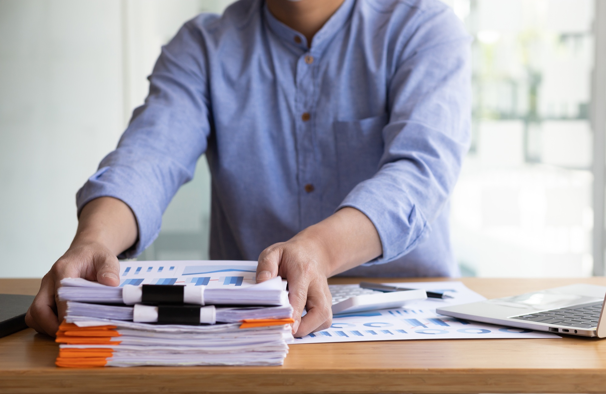 Business Documents, Auditor businessman checking working in stack of paper files.